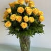 Yellow roses arranged in a clear glass vase