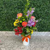 Mixed bouquet in a white vase with an orange ribbon