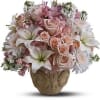 Pink and white floral arrangement in a decorative vase