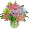 Pink lilies and mixed pastel flowers in a clear glass vase