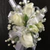 Creamy white roses arranged in a compact, rounded cluster give this white