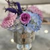 A delicate blend of pastel charm and polished presentation, this flower arrangement