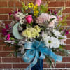 An elegant bouquet of fresh flowers partnered with a lovely stained glass