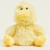 Yellow plush duck with black eyes sitting on a plain background