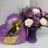 Soft lavender and blush roses nestle with pale cream carnations in a