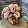 Soft yellow garden roses and pale pink roses with spray roses and