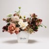 This arrangement blends soft romance with rich, moody tones. Cream and dusty-pink