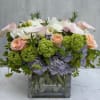 A beautiful design of lavender hydrangeas, peach roses, white peonies and soft