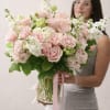 A vase arrangement designed in soft pink tones with a light, balanced