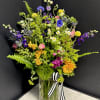 A vibrant, loose, airy, and textural mix of seasonal blossoms inspired by