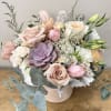 Natural tones flowers and succulent  in a velvet vase making the