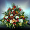 Large tropical floral arrangement with red, white, and orange blooms
