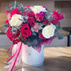Bouquet of pink and white roses in a white hat box with ribbon