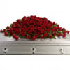 "A loving embrace of rich, regal roses in an all-red spray to