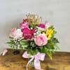 Pink and yellow mixed bouquet in a glass vase with a Mother’s Day topper