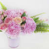 Beautiful pink peonies and tulips in pink vase