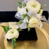 A wristlet for her and a boutonni&egrave;re for him. White roses and