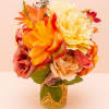 Sun-drenched citrus slices mingle with vibrant marigolds and yellow roses to create