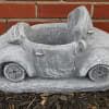 Gray concrete planter shaped like a small car