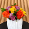 A compact cluster of mixed-color roses-cheerful pinks, sunny yellows, warm oranges and