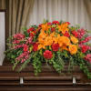 The Tribute Casket Spray from FloralFabulous is a vibrant and heartfelt expression
