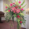 Tall standing floral spray with pink lilies, roses, and gerbera daisies