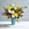 "Sun &amp; Sky" is a bright, uplifting arrangement featuring golden blooms, soft