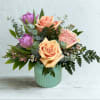 A charming blend of soft, romantic hues, this arrangement features lush peach