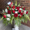 A bold spray of red roses and carnations centered against pure white