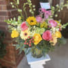 A bright, cheerful arrangement that reads like sunshine and confetti-perfect as a