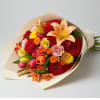 Bouquet of mixed red, orange, pink, and yellow flowers wrapped in paper