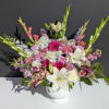 Mixed pink and white floral arrangement in a white vase