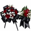 Deep crimson roses clustered with delicate white filler flowers make an immediate