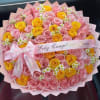 Pastel pink and yellow 75 roses with white daisies, wrapped in pink