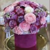 Pink and purple rose bouquet in a magenta hatbox