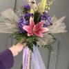 A single large pink lily takes center stage in this prom bouquet