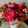 Stunning assortment of premium blooms in coral and deep pink shades: peonies