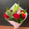 1/2 Dozen Roses with a beautiful lily to complete its look. (May