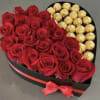 Heart-shaped box of red roses and gold-wrapped chocolates