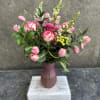 Bi-color roses, tulips, carnations, berries , snap dragons, curly willow. a mix