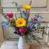 Mixed bouquet in a white vase with yellow daisies and pink tulips