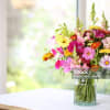 Mixed bouquet of colorful flowers in a clear glass vase
