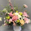 This is a loose, garden-style floral arrangement designed with a natural, airy