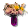 Soft chrysanthemums and alstroemeria mingle with bright yellow roses to create a