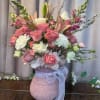 A lush, romantic display of pink and white blooms arranged with airy