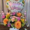 Bright, cheerful blooms in a rounded white hat box make this flower