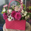 Pink rose bouquet in a bright pink handbag-style container