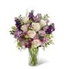 Creamy white roses mingle with lavender-hued stock and purple alstroemeria in a