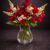 Lush red roses take center stage in this romantic vase arrangement, the
