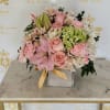 Soft pink roses and lilies take center stage in this All about